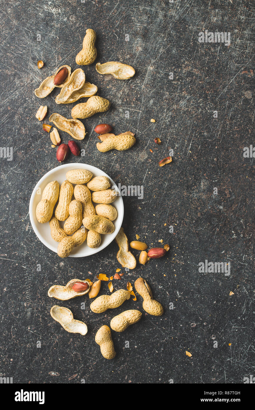 The dried peanuts. Groundnuts on old table. Top view. Stock Photo