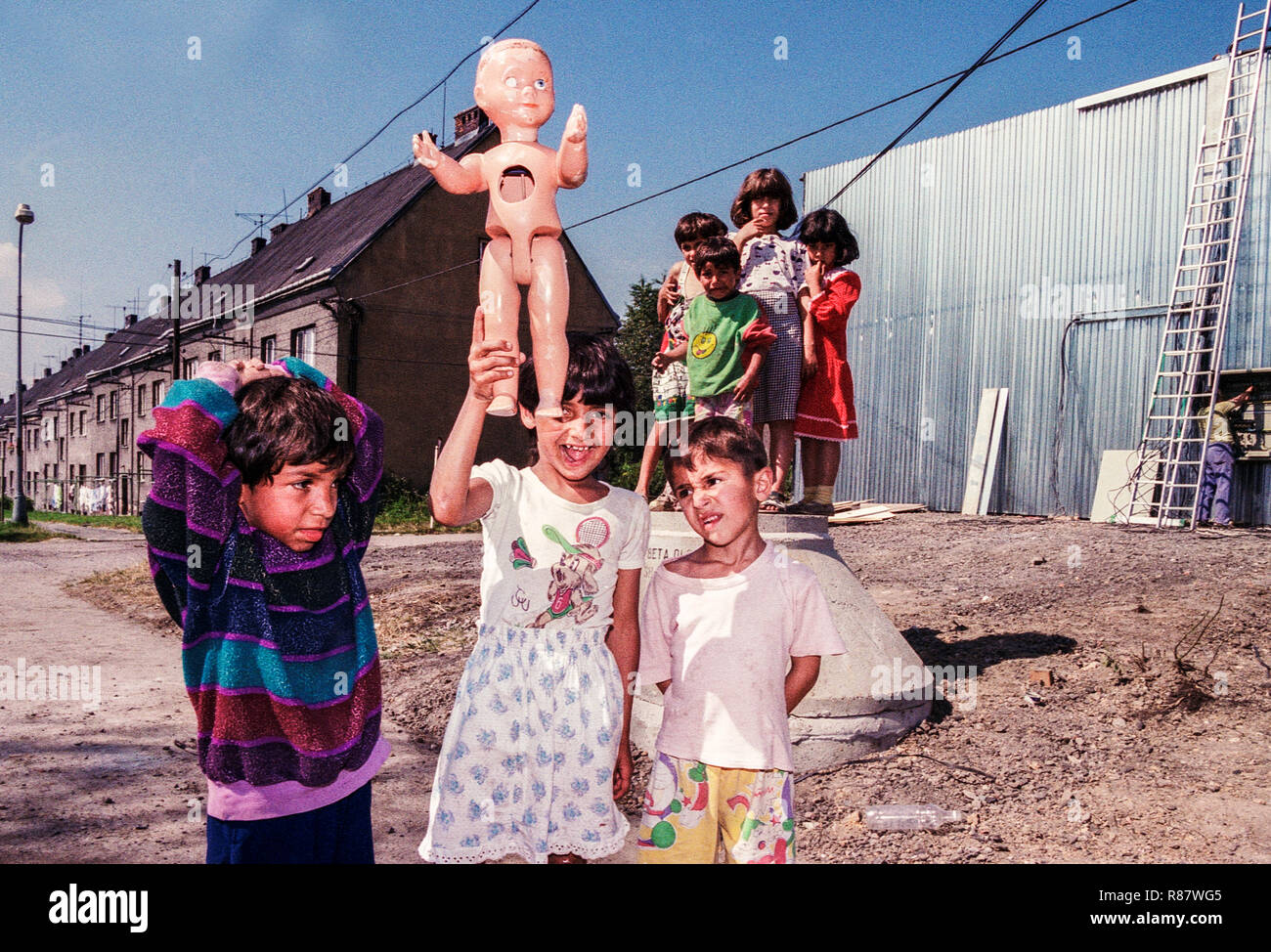 Gypsies children playing with dolls broken doll, Gypsy people, Ostrava Czech Republic Stock Photo