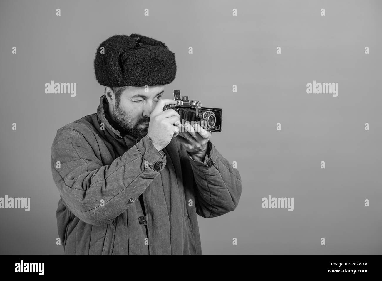 Bearded man with retro camera, studio shott. Oldfashioned clothing