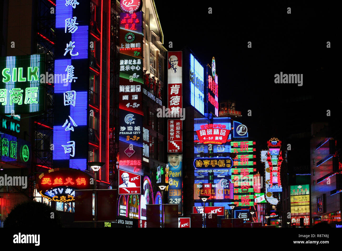 City street illuminated by neon lights and signs in all