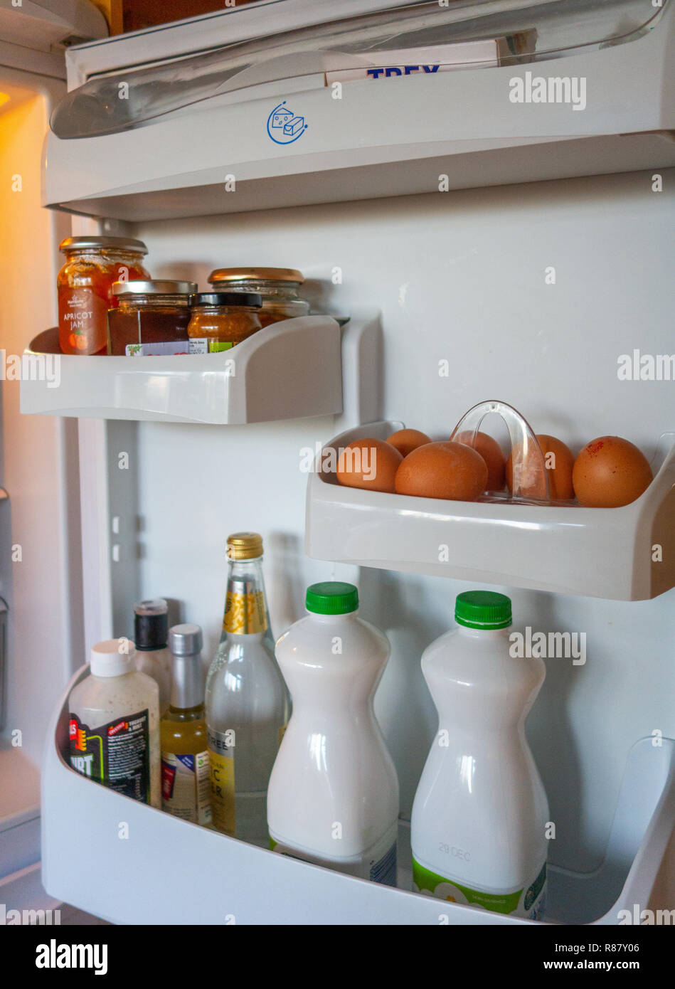 The inside shelves of a Fridge Door and the contents that are owned by an 90 year old lady in England Stock Photo