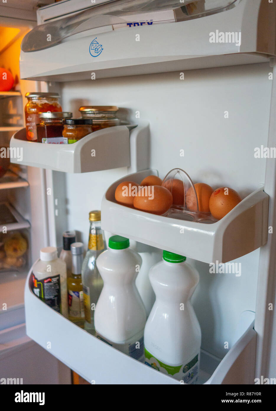 The inside shelves of a Fridge Door and the contents that are owned by an 90 year old lady in England Stock Photo