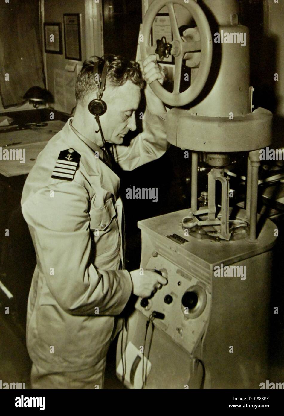 Captain G. Eklund, Merchant Marine, checks a ship's radio direction