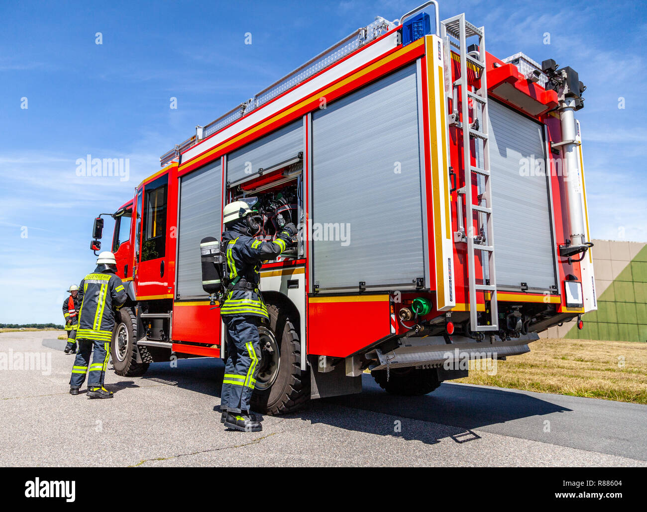 German fire engine with fireman arround stands on a accident Stock Photo