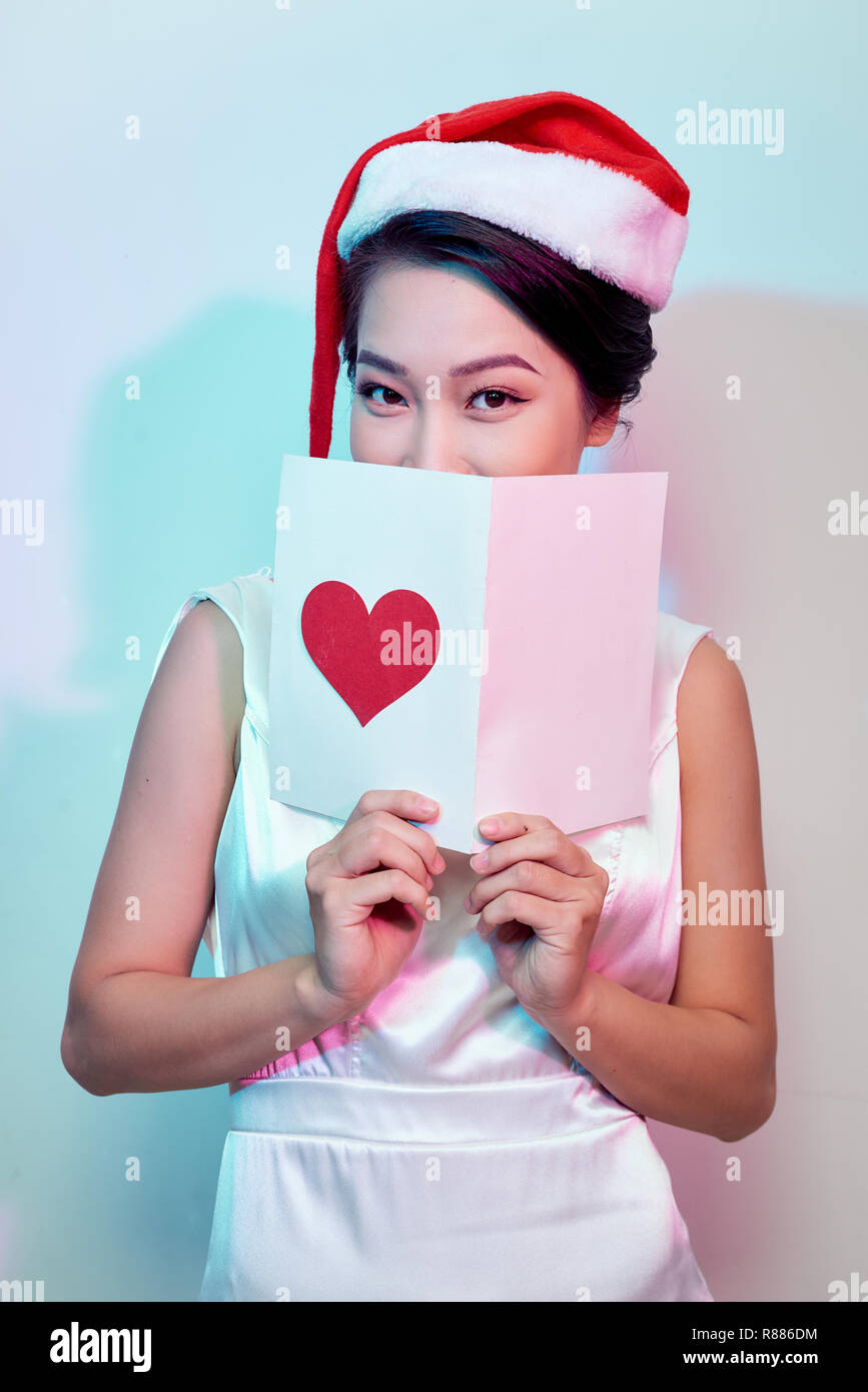 Image of happy beautiful female reading romantic postcard with big red ...