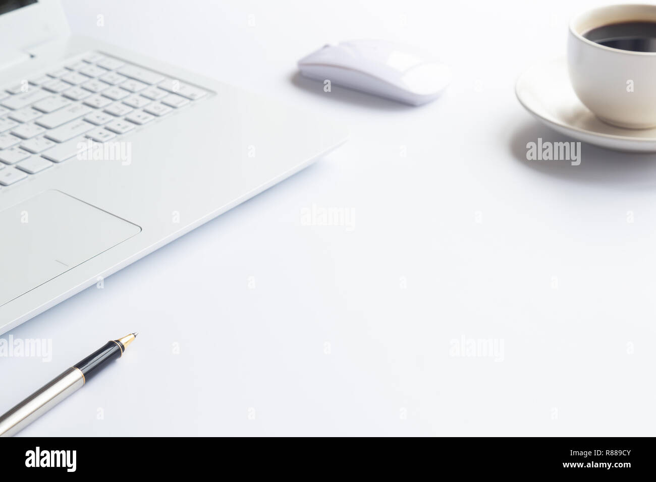White desk office with laptop, smartphone and other work supplies with cup of coffee. Top view with copy space for input the text. Designer workspace  Stock Photo
