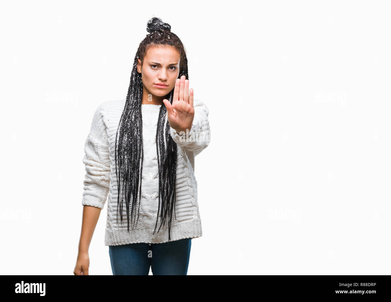 Young braided hair african american girl wearing sweater over isolated background doing stop sing with palm of the hand. Warning expression with negat Stock Photo