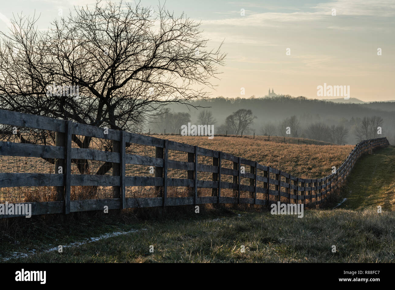 Frosty Wisconsin farm field and church with picket fence. Stock Photo