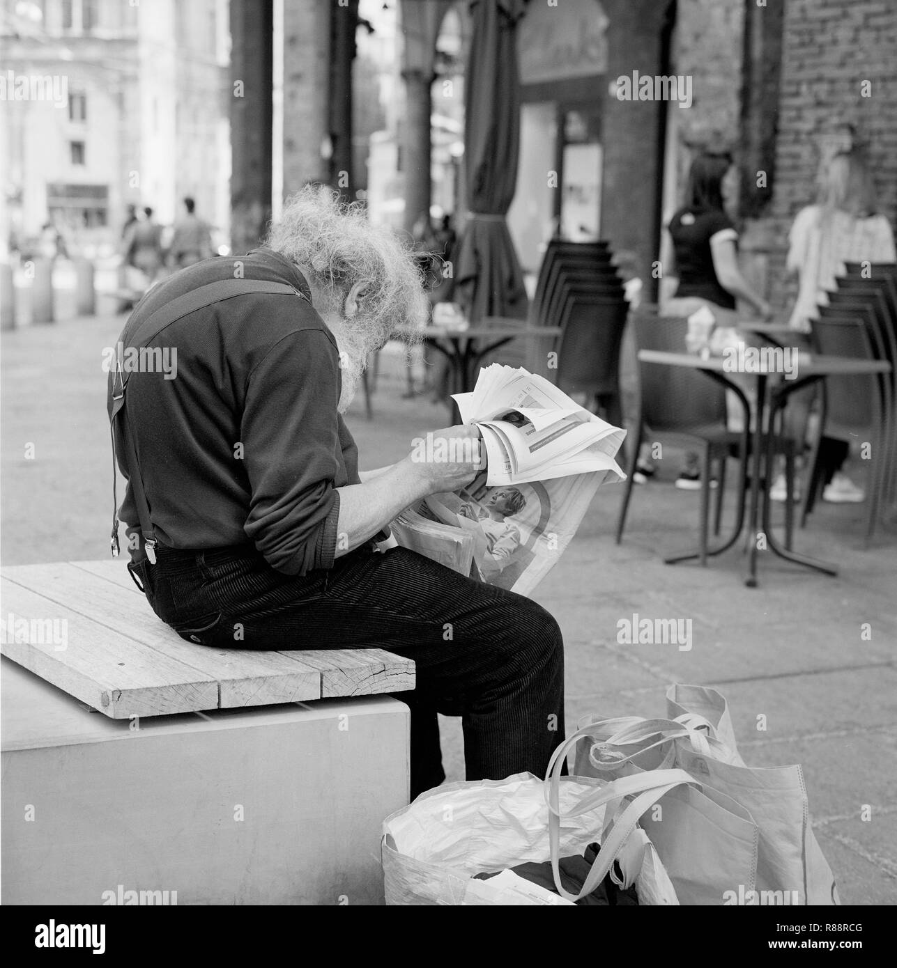 Old man with newspaper. Film photography, Rolleiflex. Stock Photo