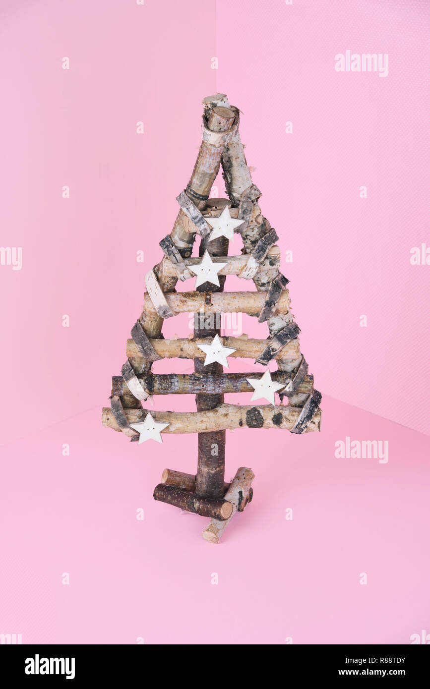 Christmas wooden tree over light blue background Stock Photo - Alamy