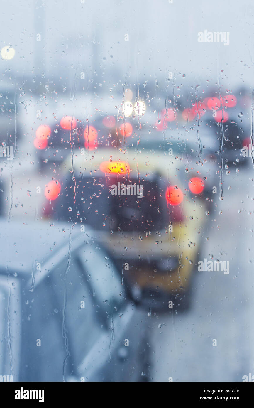 rain droplets on car windshield, traffic in city Stock Photo - Alamy