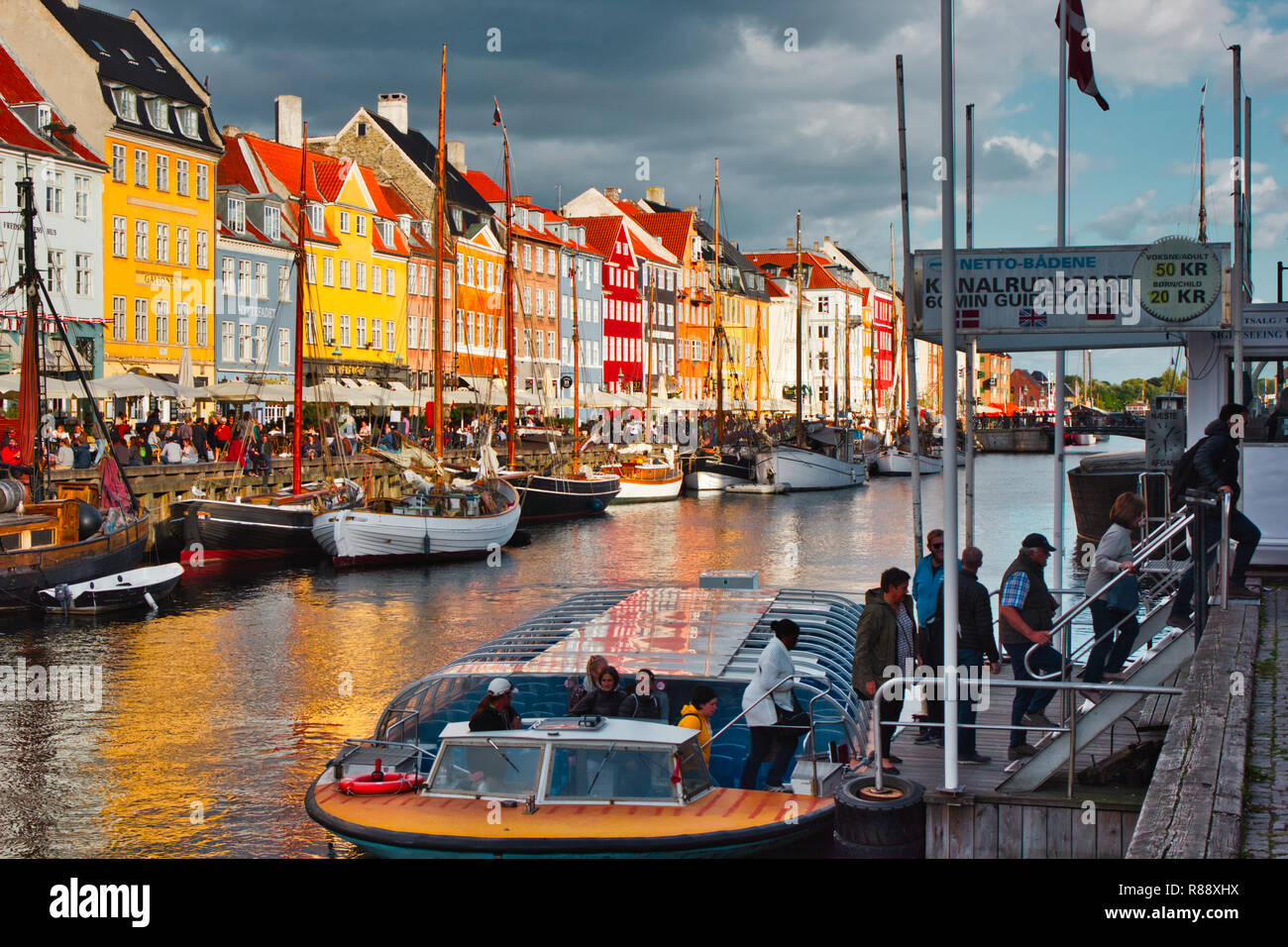 Tourists sightseeing boat and brightly coloured townhouses, Nyhavn Canal, Nyhavn, Copenhagen, Denmark, Scandinavia Stock Photo