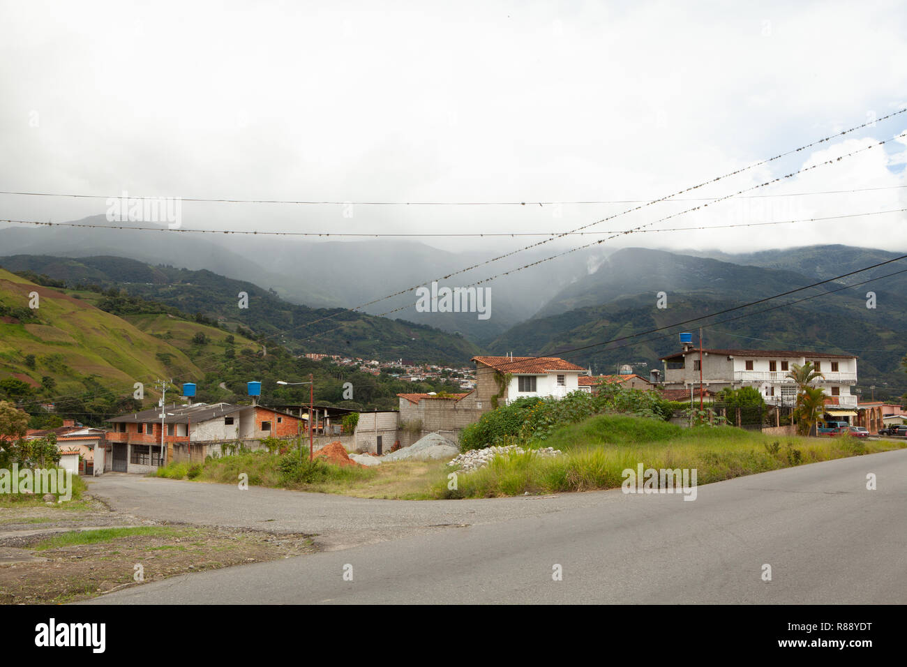 View of houses and empty suburban road with distant mountains,  Merida, Venezuela, South America Stock Photo