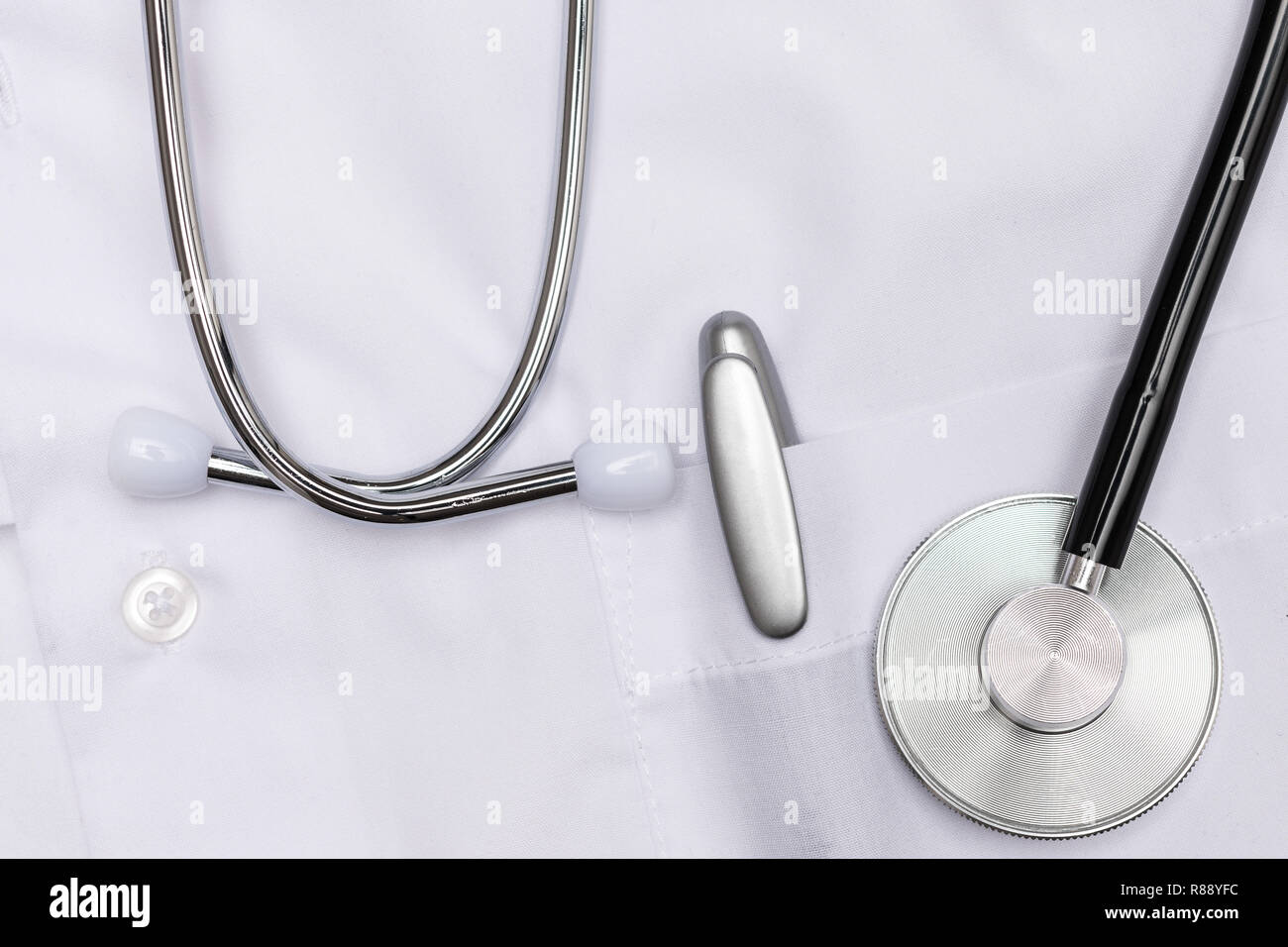 stethoscope and pen on white smock Stock Photo