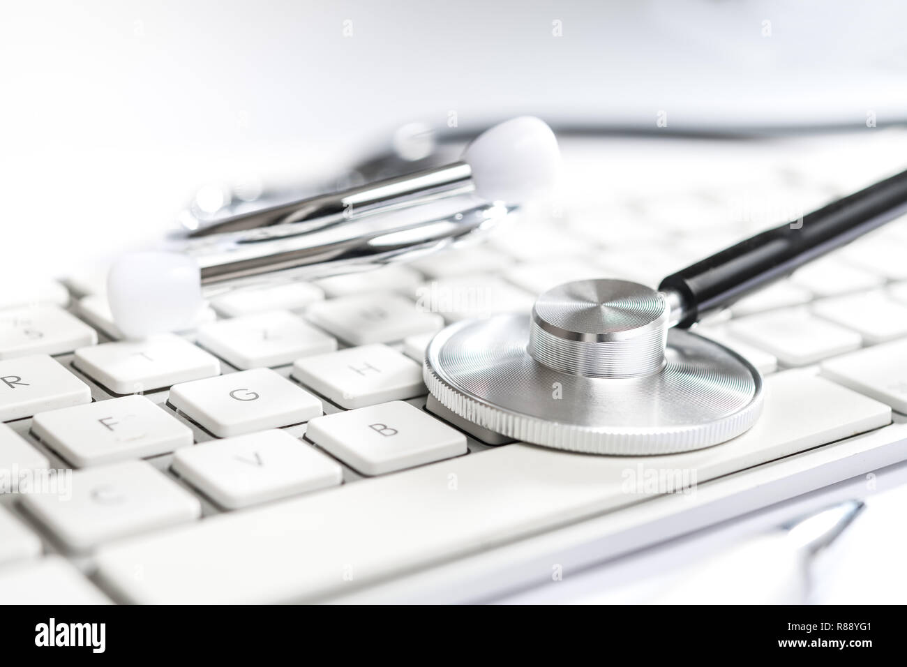 stethoscope on white table with computer keyboard Stock Photo - Alamy