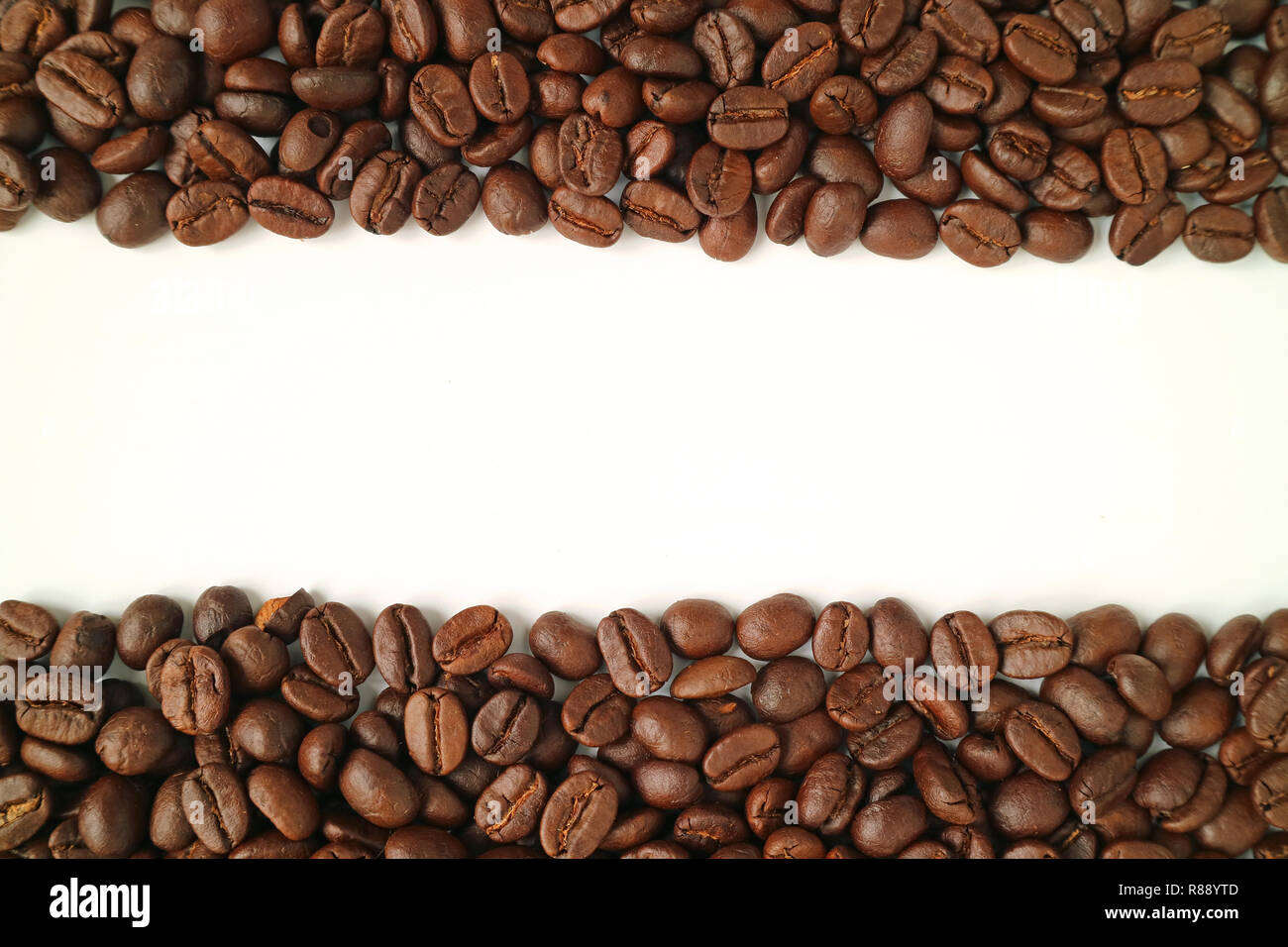 Heap of roasted coffee beans on white background, top view with free ...