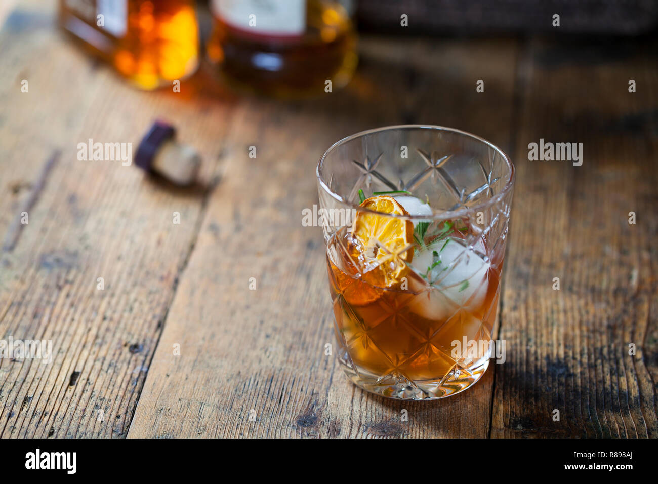 Old fashioned, whiskey drink with rosemary ice cubes Stock Photo Alamy