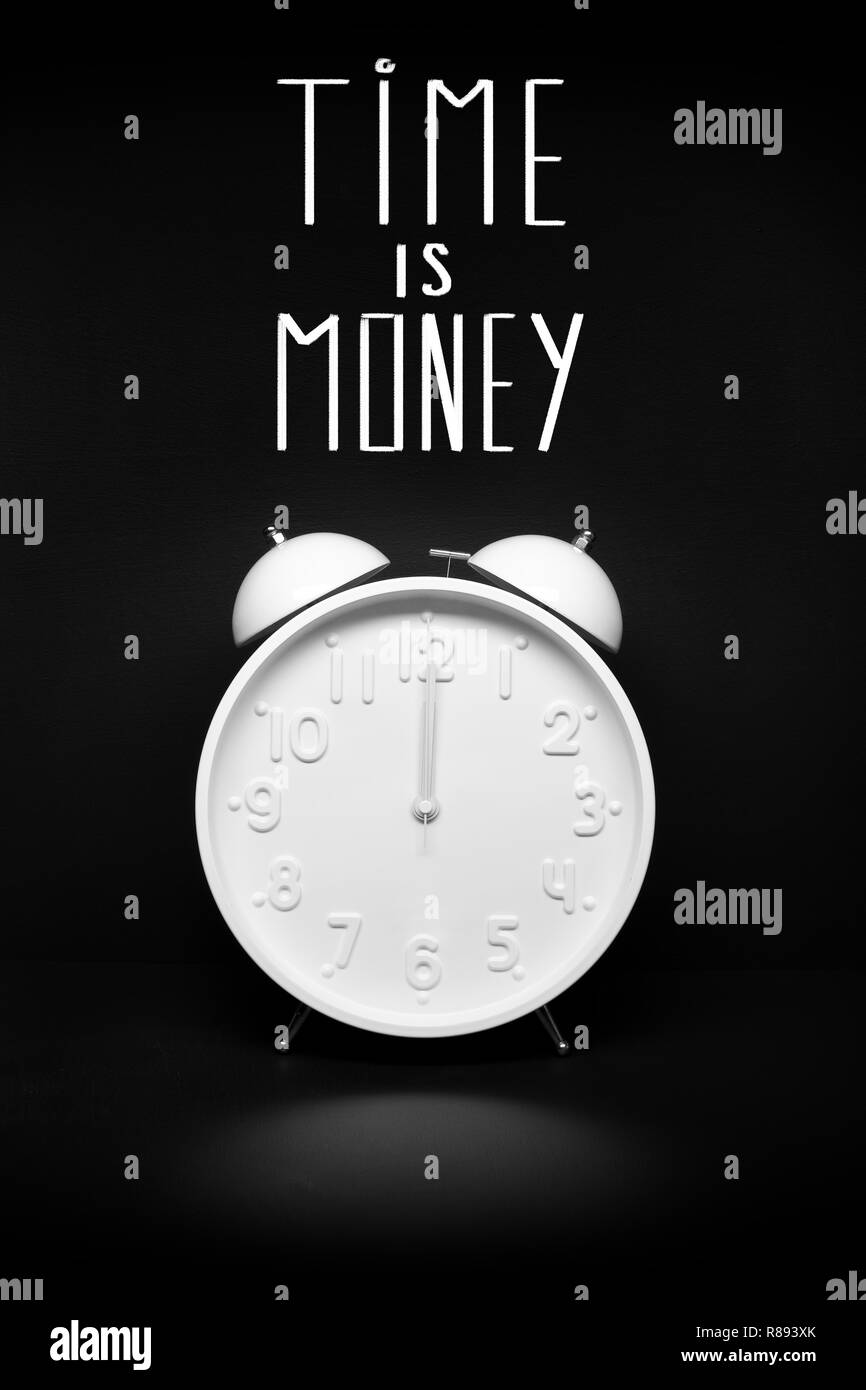 Time is money concept. Retro Alarm clock isolated on black background