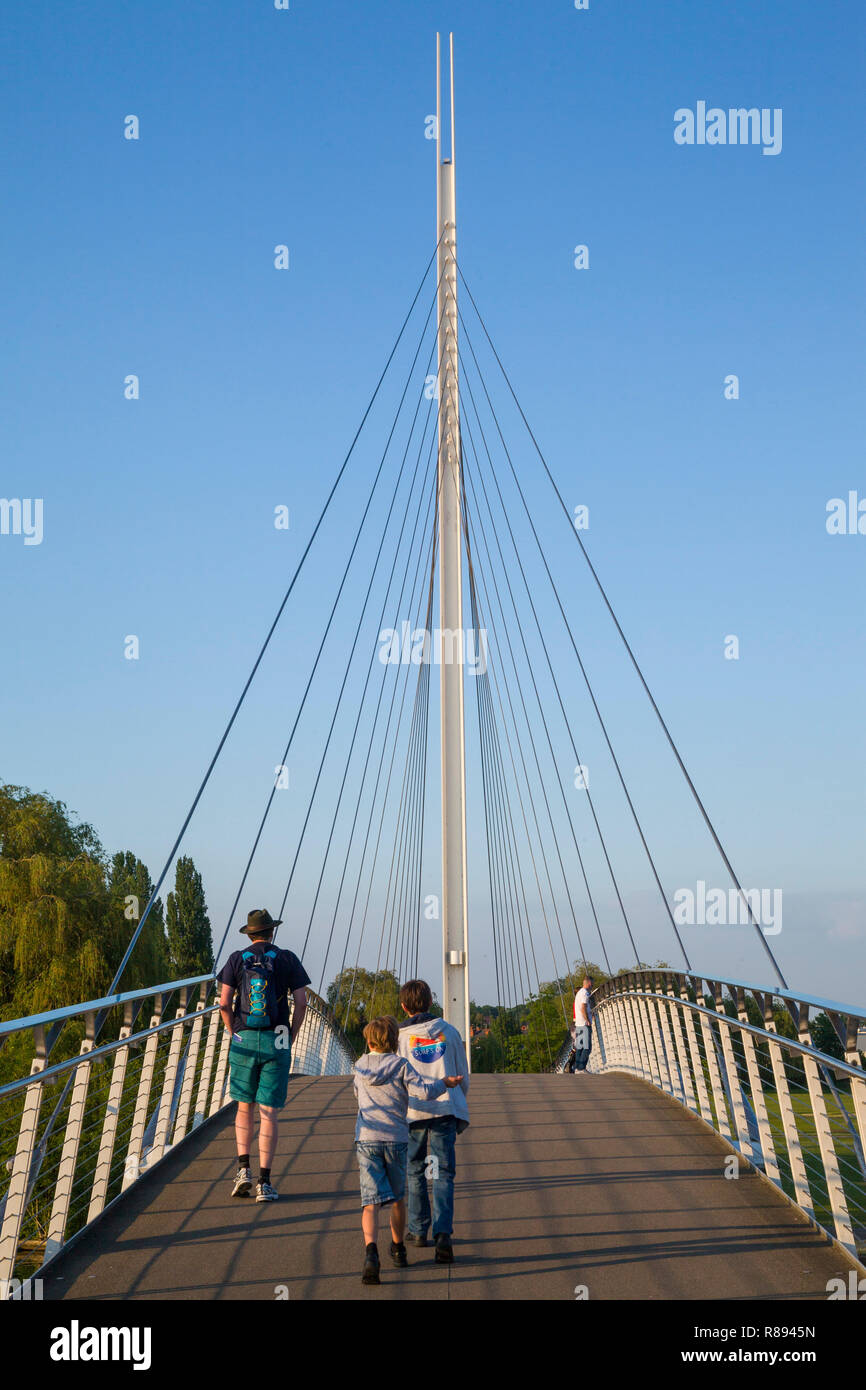 Two children and their father cross the Christchurch bridge in Reading, Berkshire Stock Photo