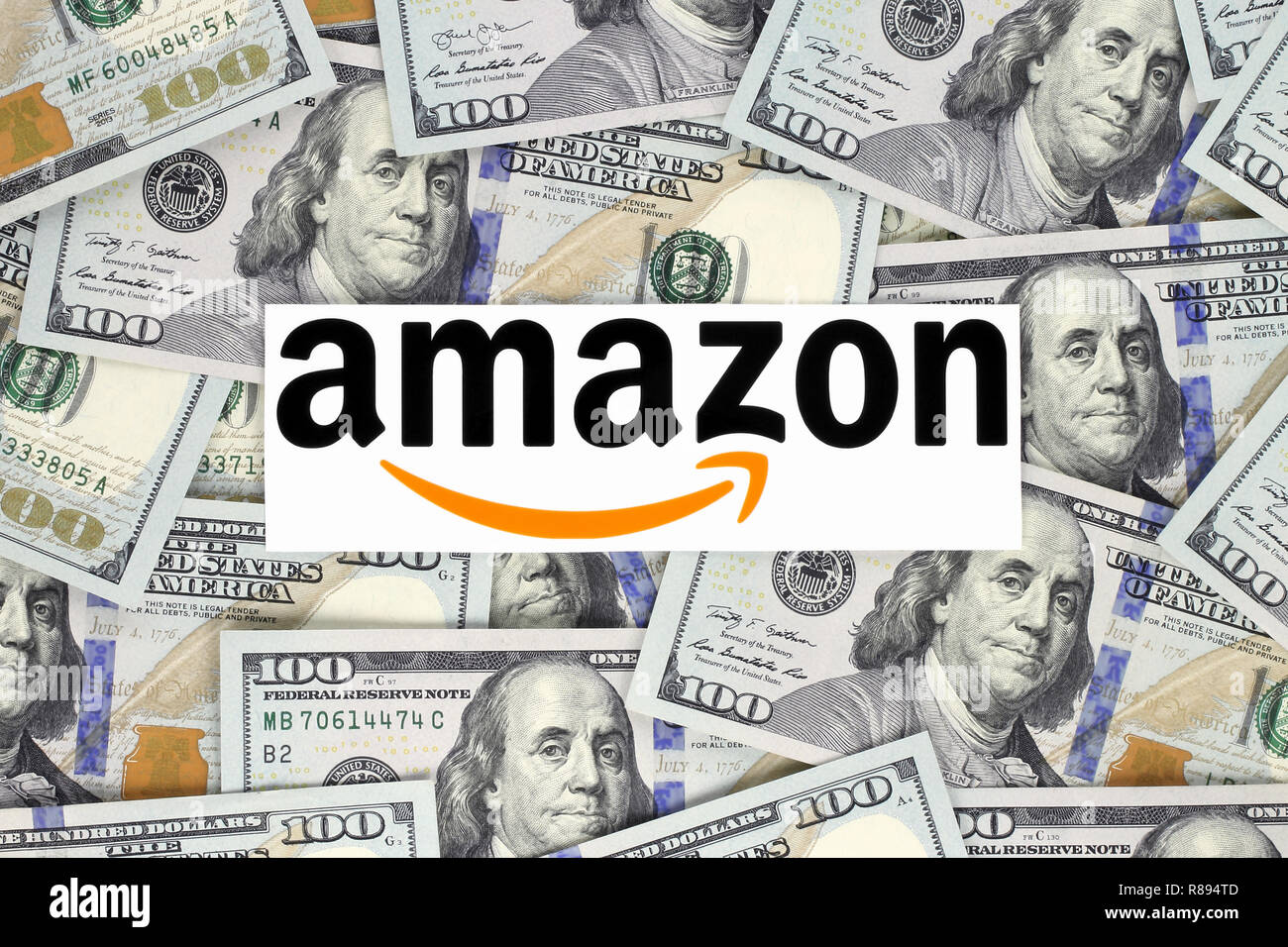 Kiev, Ukraine - September 07, 2018: Amazon logo printed on paper, cut and placed on money background.Amazon is an American electronic commerce company Stock Photo
