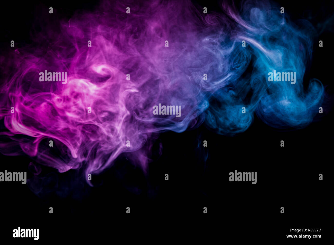 Cloud of pink and blue smoke on a black isolated background. Background ...
