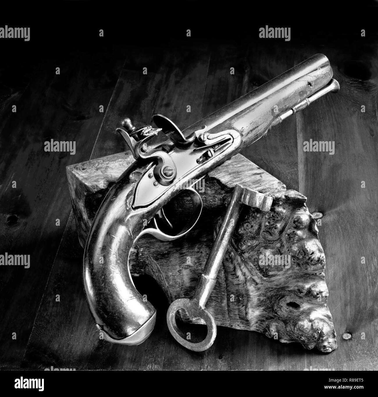 English flintlock pistol and jailers key made in the early 1800's in black and white. Stock Photo