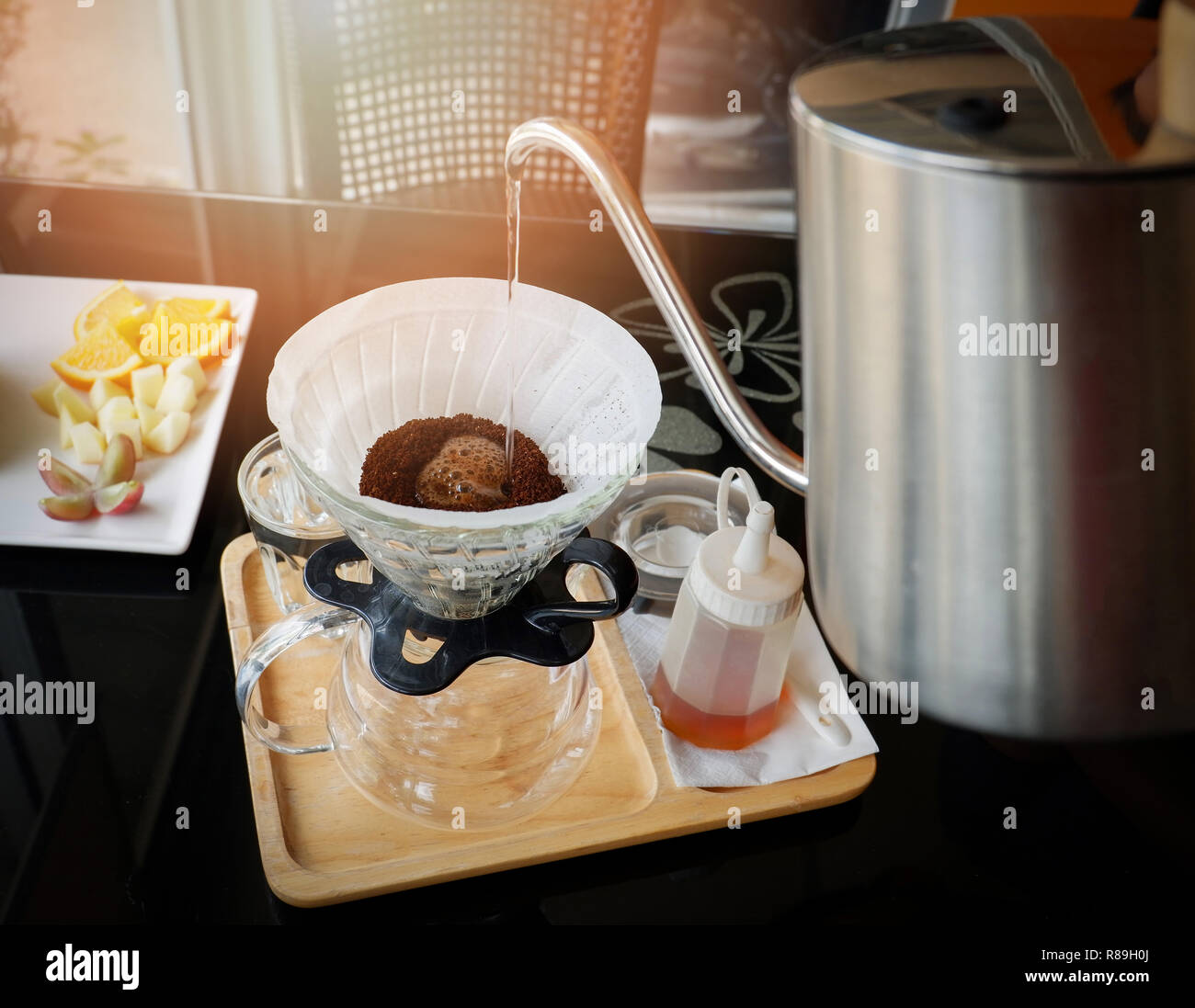 drip coffee barista pouring water on filtered coffee drip brewing
