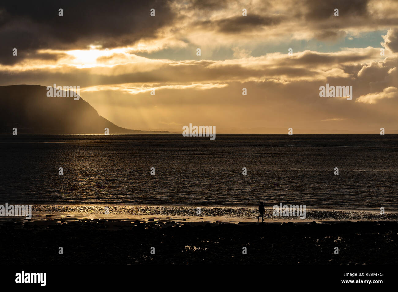 Sunset with clouds over the Irish Sea at Llandudno West Shore, North Wales Stock Photo