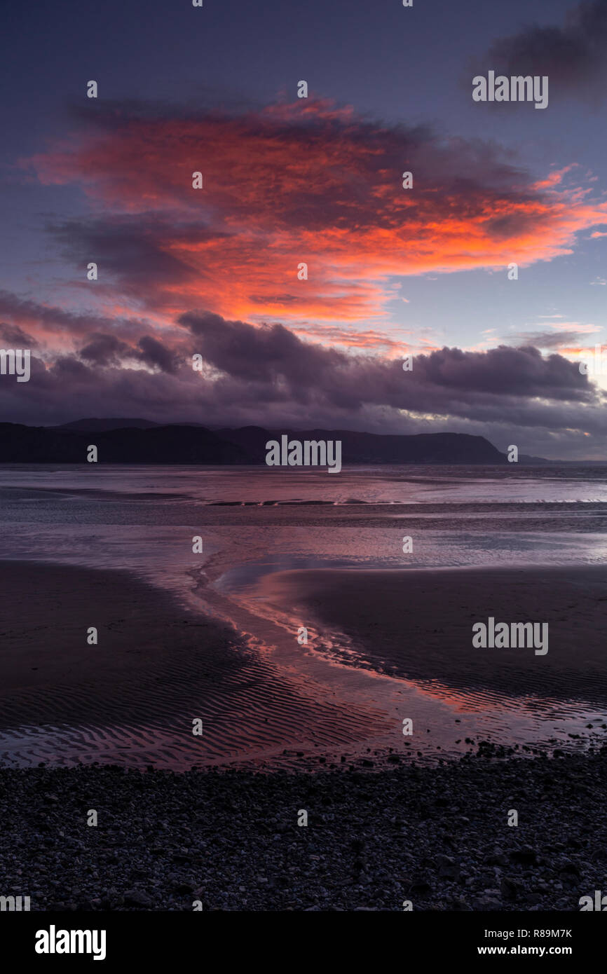 Sunlit clouds at sunset over the North Wales coast at Llandudno est Shore Stock Photo