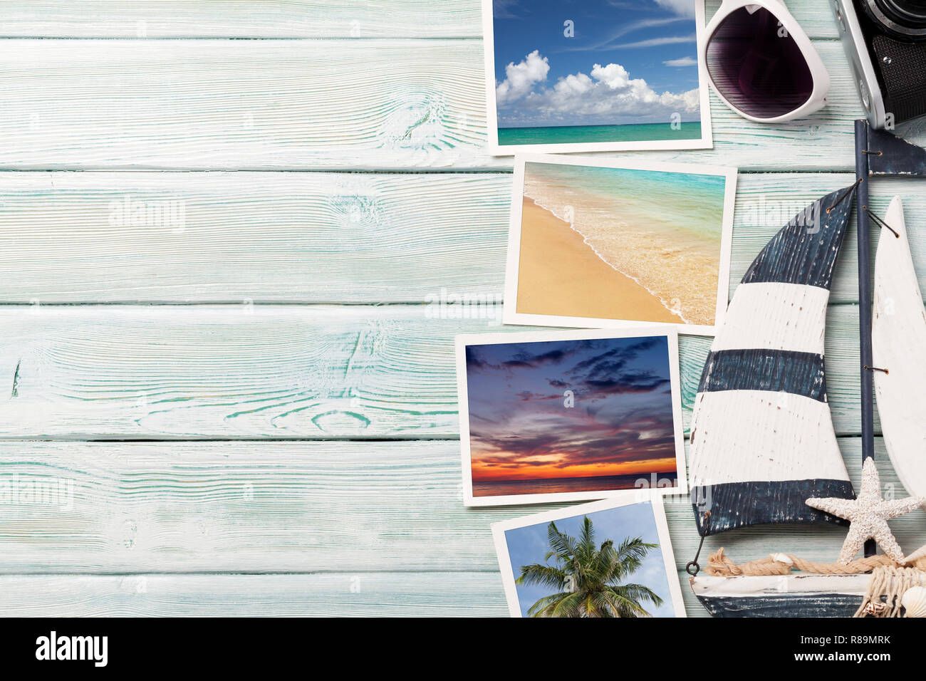 Travel vacation background concept with sunglasses, camera and weekend photos on wooden backdrop. Top view with copy space. Flat lay. All photos taken Stock Photo