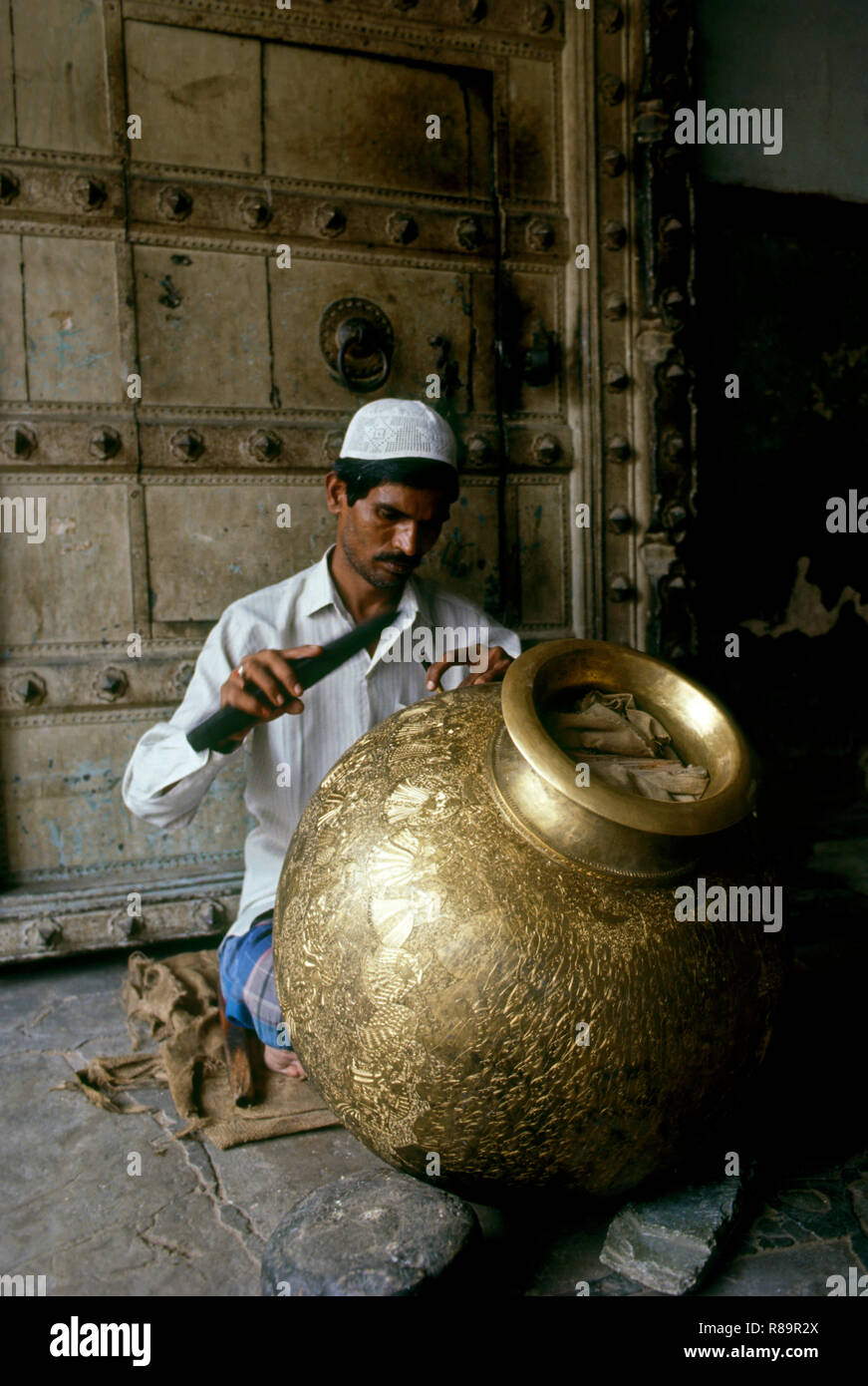 man making brass work on pot, jaipur, rajasthan, india Stock Photo Alamy