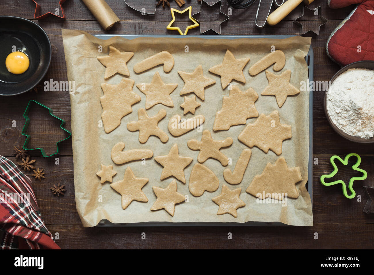 Homemade christmas cookies on parchment. Xmas. The process of baking homemade cookies. View from above. Stock Photo