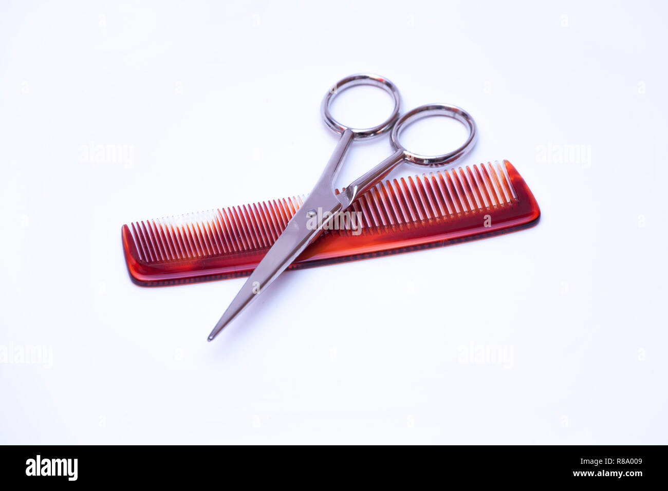 Hairdressers Scissors And Comb On A White Background Stock Photo