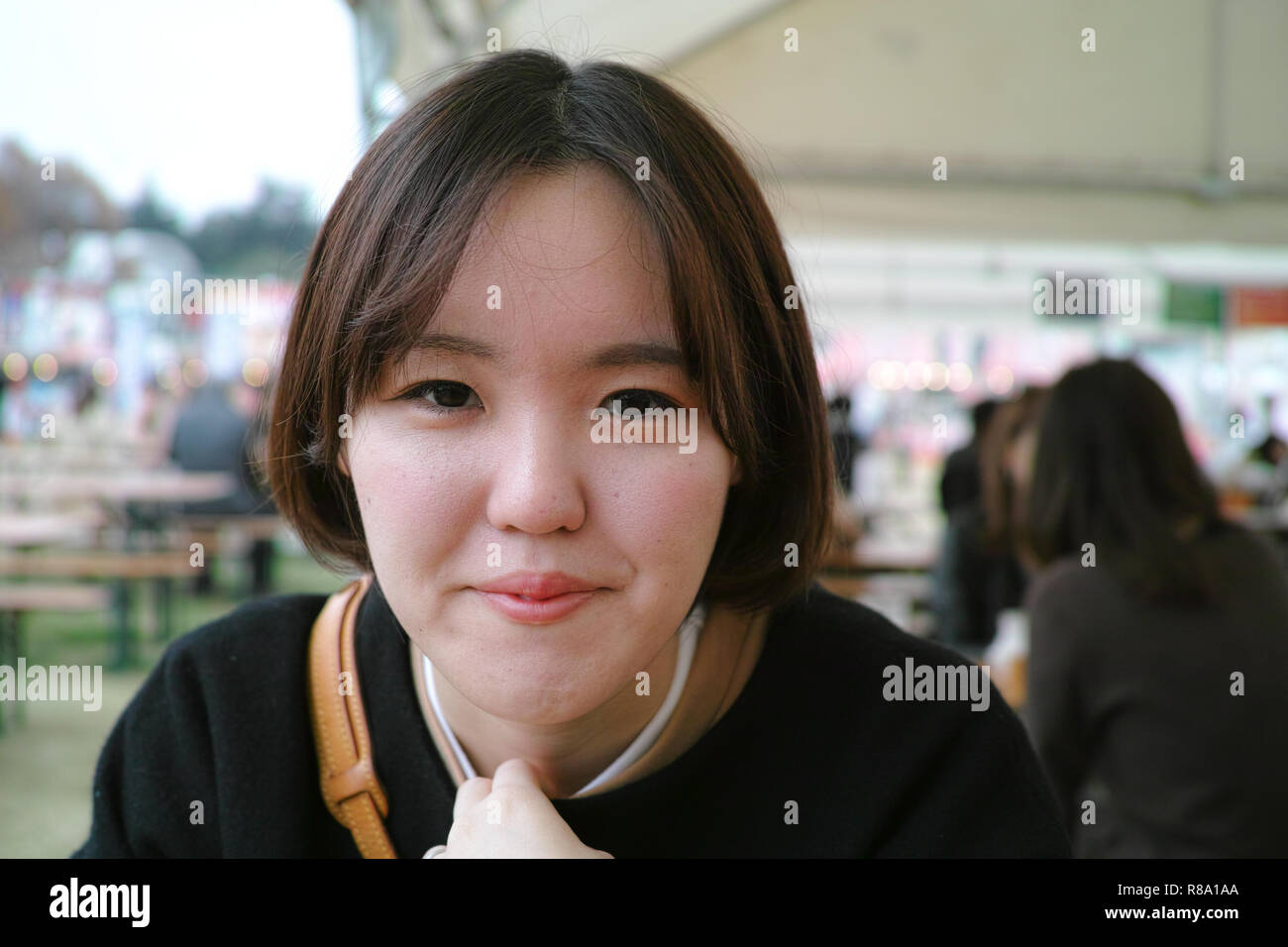 A pretty Japanese woman looking into the camera shyly Stock Photo