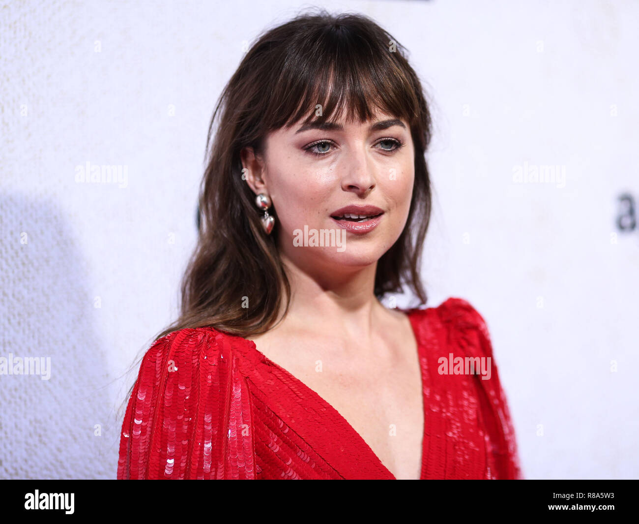 HOLLYWOOD, LOS ANGELES, CA, USA - OCTOBER 24: Actress Dakota Johnson wearing a Celine dress, Sophie Buhai earrings, and Giuseppe Zanotti heels arrives at the Los Angeles Premiere Of Amazon Studio's 'Suspiria' held at the ArcLight Cinerama Dome on October 24, 2018 in Hollywood, Los Angeles, California, United States. (Photo by Xavier Collin/Image Press Agency) Stock Photo