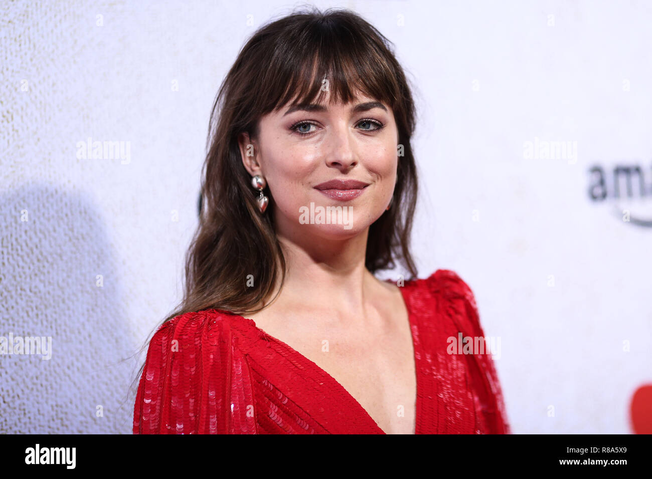 HOLLYWOOD, LOS ANGELES, CA, USA - OCTOBER 24: Actress Dakota Johnson wearing a Celine dress, Sophie Buhai earrings, and Giuseppe Zanotti heels arrives at the Los Angeles Premiere Of Amazon Studio's 'Suspiria' held at the ArcLight Cinerama Dome on October 24, 2018 in Hollywood, Los Angeles, California, United States. (Photo by Xavier Collin/Image Press Agency) Stock Photo
