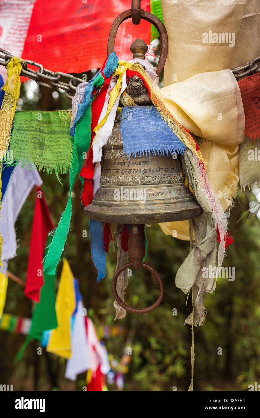 Brass bell and prayer flags at temple in the hills of Annapurna Himal, Nepal, Himalayas, Asia Stock Photo