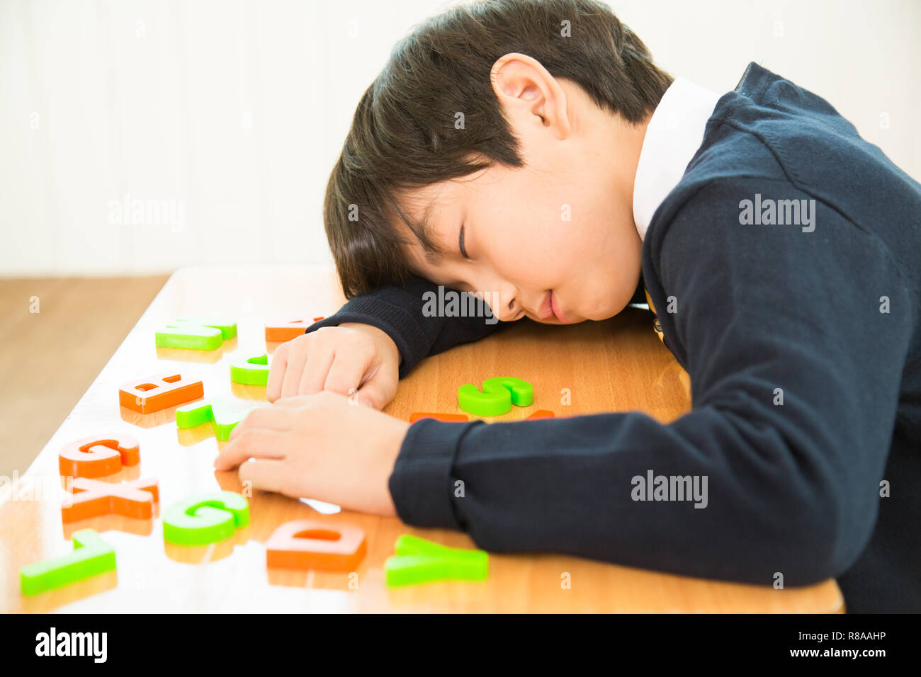 Young Student Sleeping On The Desk Stock Photo