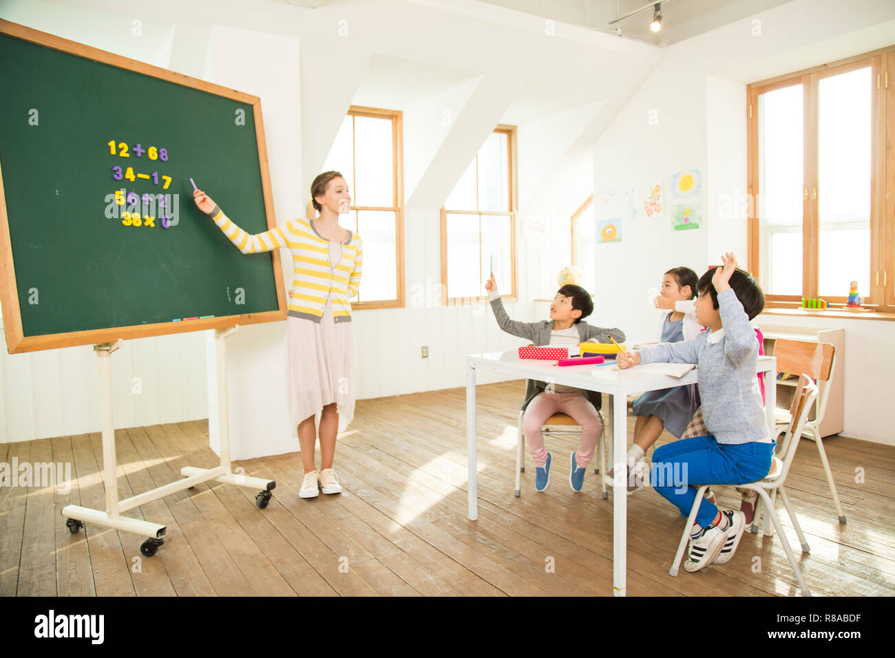 Young Students Learning With A Foreign Female Teacher Stock Photo - Alamy