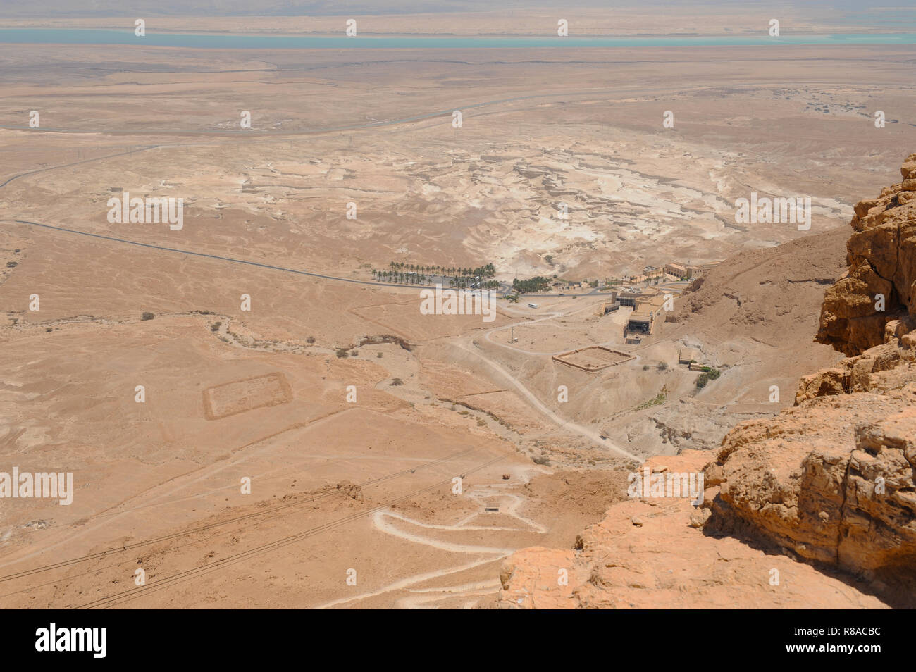 Touring Masada rock plateau with ruined palaces of brutal King Herod in Judaean Desert of Israel reminding mass suicide of Jews fighting with Romans. Stock Photo