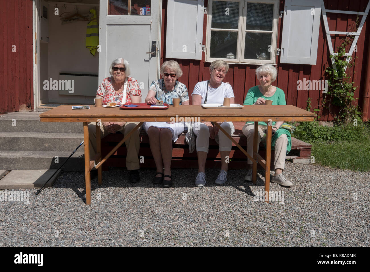 Seniors drink coffee on a hot summer day, Upplands Väsby, Sweden. Stock Photo