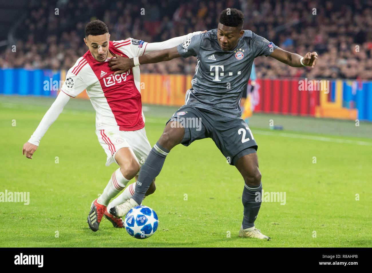 Amsterdam, Niederlande. 13th Dec, 2018. Noussair MAZRAOUI (left, Ajax) versus David ALABA (M), Action, duels, Soccer Champions League, Group stage, Group E, matchday 6, Ajax (Ajax) - FC Bayern Munich (M) 3: 3, 12.12. 2018 in Amsterdam/Netherlands. | Usage worldwide Credit: dpa/Alamy Live News Stock Photo