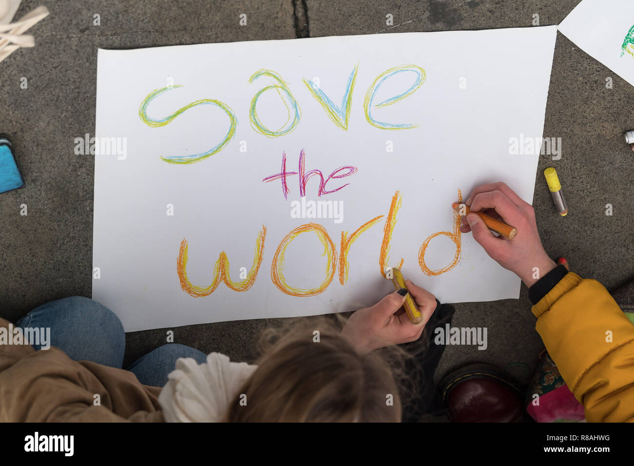 Berlin, Germany. 14th Dec, 2018. Students demonstrate in the city centre under the motto 'Future without climate chaos' and paint posters with the inscription 'save the world'. Credit: Peter Kneffel/dpa/Alamy Live News Stock Photo