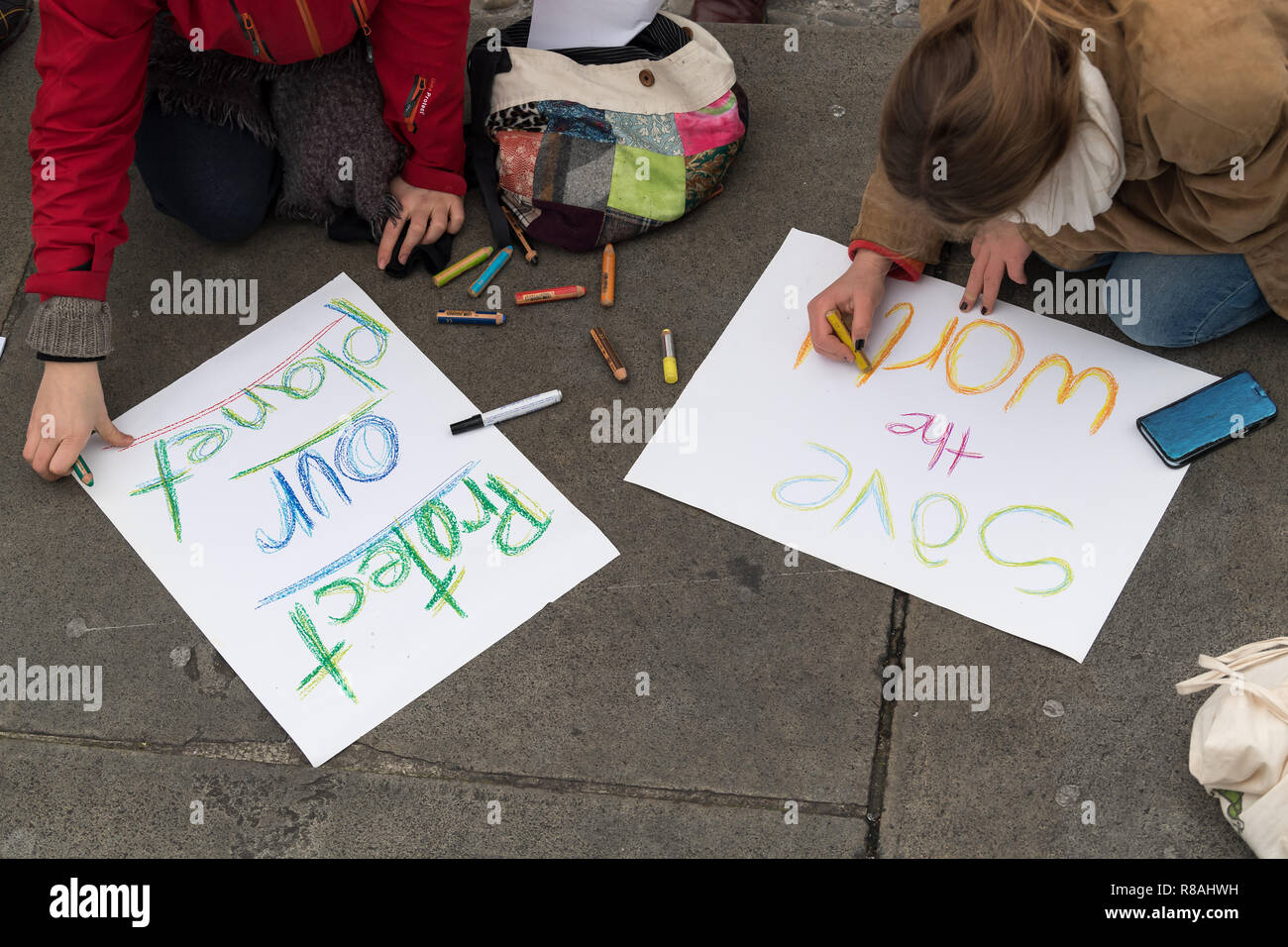 Berlin, Germany. 14th Dec, 2018. Students demonstrate in the city centre under the motto 'Future without climate chaos' and paint posters with the inscription 'save the world' and 'Protect our planet'. Credit: Peter Kneffel/dpa/Alamy Live News Stock Photo