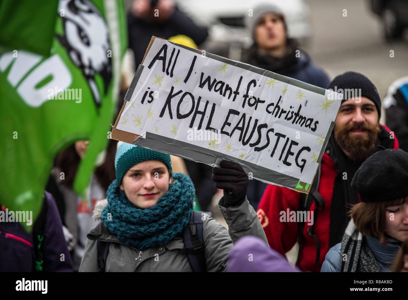 Munich, Bavaria, Germany. 14th Dec, 2018. A demonstrator voices her wish to exit from coal usage. As part of a worldwide action, 100 students and concerned citizens participated in a climate strike at Munich's Max Joseph Platz. The protestors are calling on world governments to take decisive action against climate change. The demonstration ended with an artistic action where the participants used chalk to color the ground with environmental designs and slogans. One of the designs was a crossed out swastika, signifying the group's stance against Nazis, which the police allege was n Stock Photo