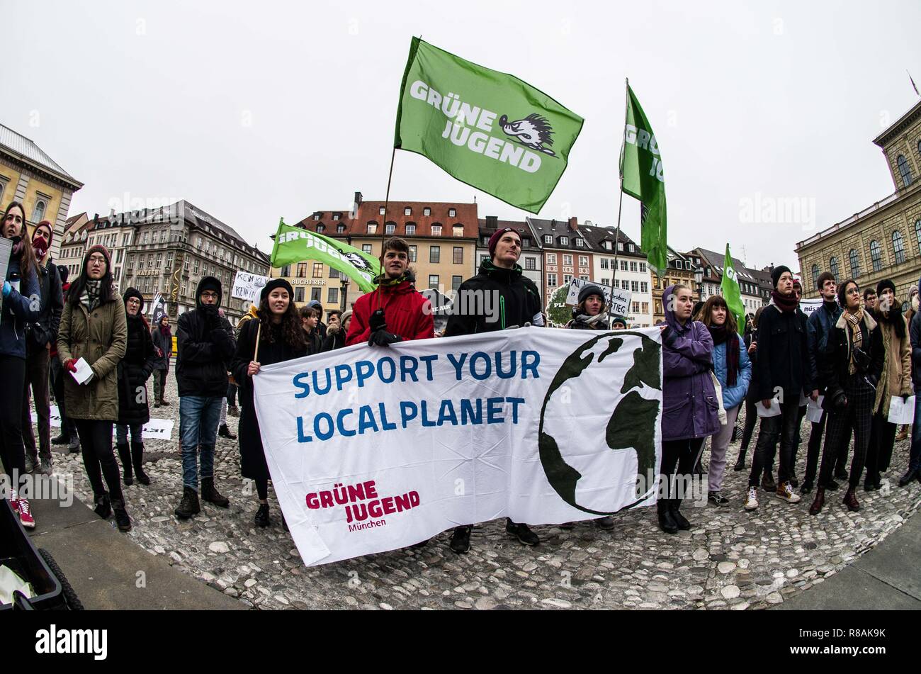 Munich, Bavaria, Germany. 14th Dec, 2018. As part of a worldwide action, 100 students and concerned citizens participated in a climate strike at Munich's Max Joseph Platz. The protestors are calling on world governments to take decisive action against climate change. The demonstration ended with an artistic action where the participants used chalk to color the ground with environmental designs and slogans. One of the designs was a crossed out swastika, signifying the group's stance against Nazis, which the police allege was not discernible as such and the organizer received a crimi Stock Photo