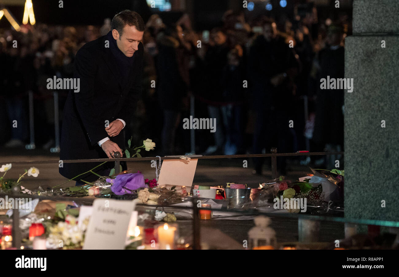 14 December 2018, France (France), Straßburg: Emmanuel Macron, President of France, lays down a flower. Two days after the Strasbourg terrorist attack with four dead, police killed the suspected assassin Chekatt. Photo: Marijan Murat/dpa Stock Photo