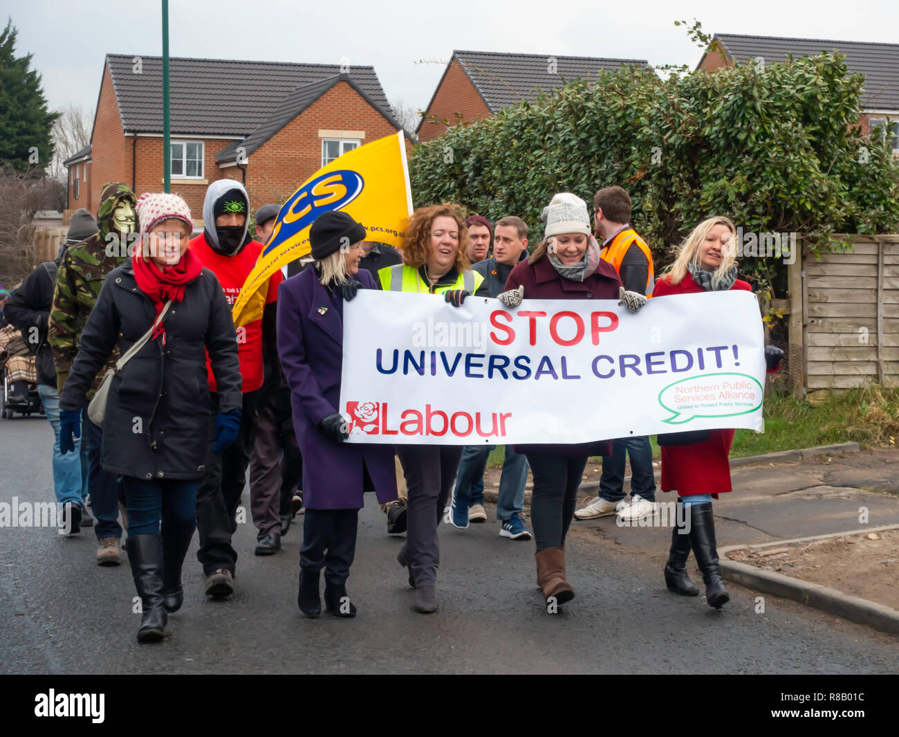 Guisborough Cleveland North Yorkshire, UK. 15th Dec, 2018.  Marchers protesting against the introduction of Universal Credit.    UC is a new benefits system with a single monthly payment replacing several other benefits, being rolled out throughout the UK.  As it is paid monthly in arrears claimants often suffer financial hardship when it is first introduced.   This marching demonstration is against Universal Credit but particularly because in this area it is being introduced before Christmas when the financial hardship will be particularly unwelcome. Credit: Peter Jordan NE/Alamy Live News Stock Photo
