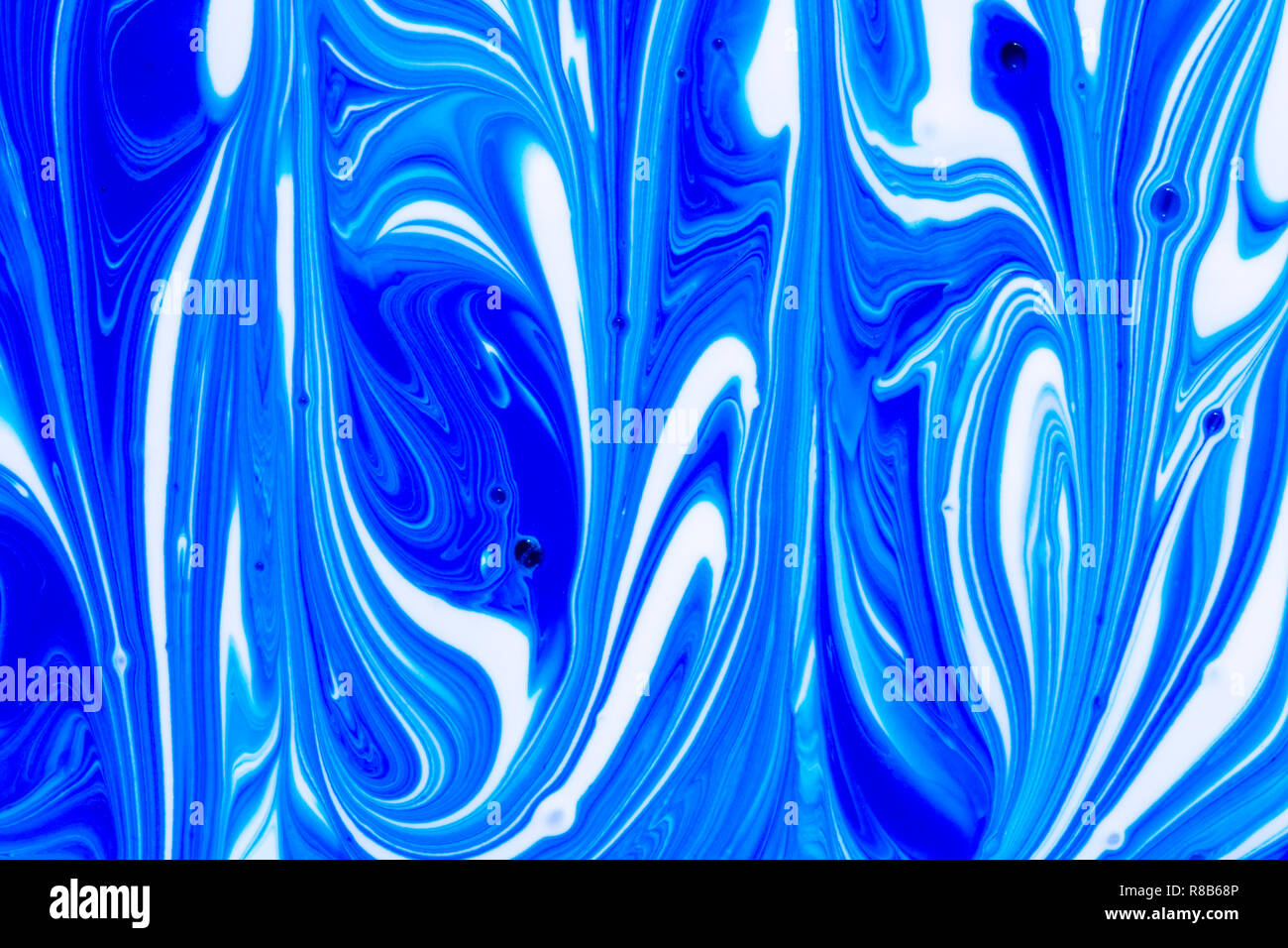 Abstract background of blue and white liquid paint swirls Stock Photo ...