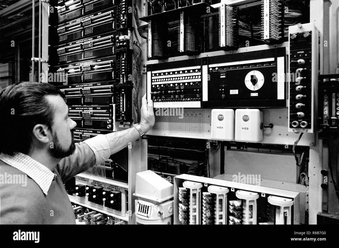 An engineer checking the meter pulse supply in a crossbar telephone